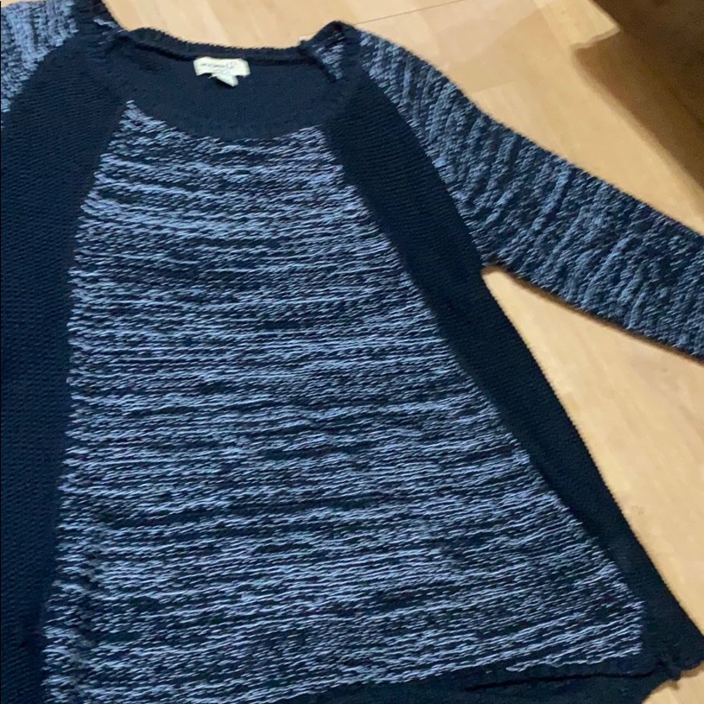 black and white sweater , higher in front.